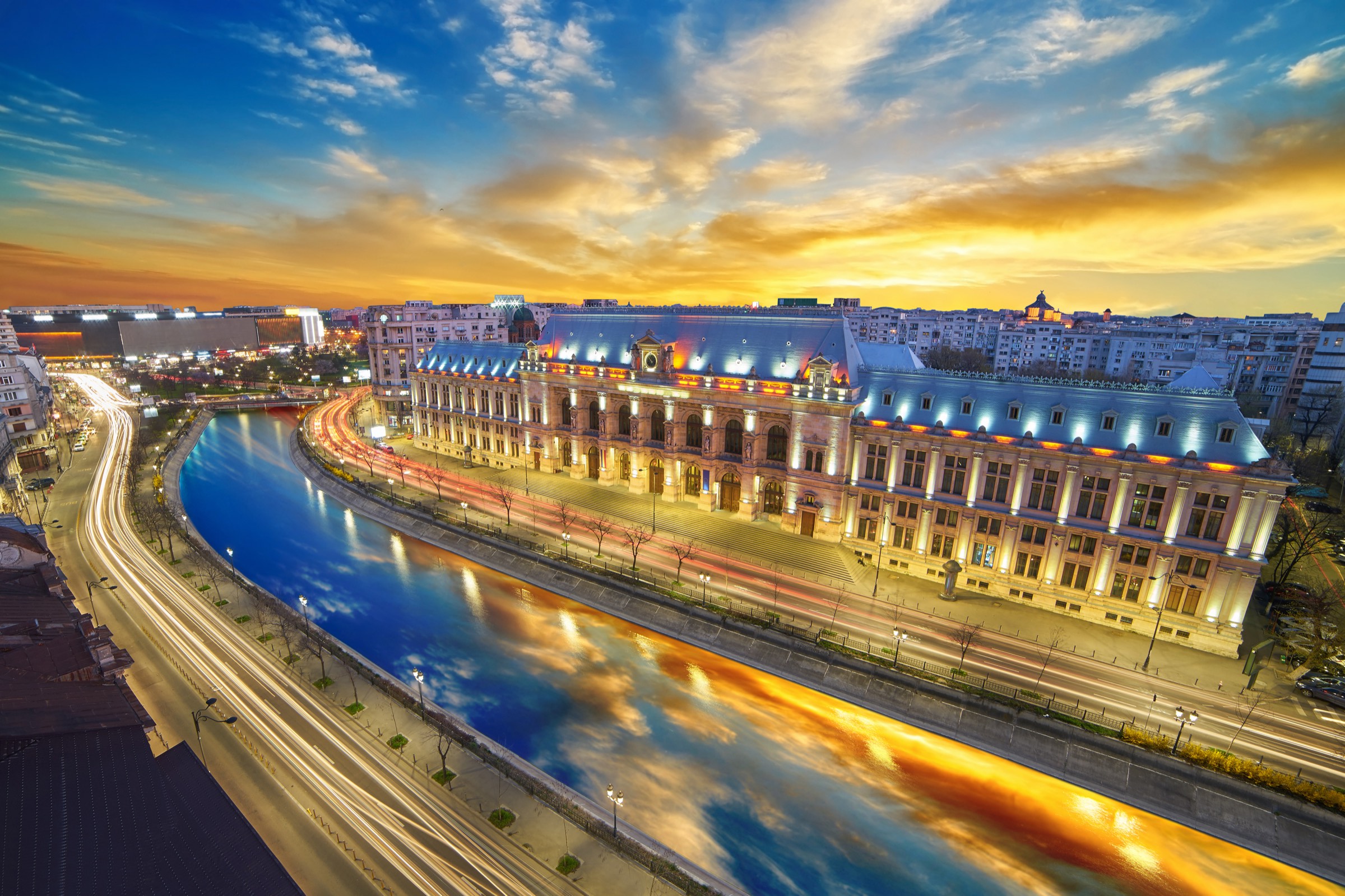 Bucharest riverfront lit up at dusk