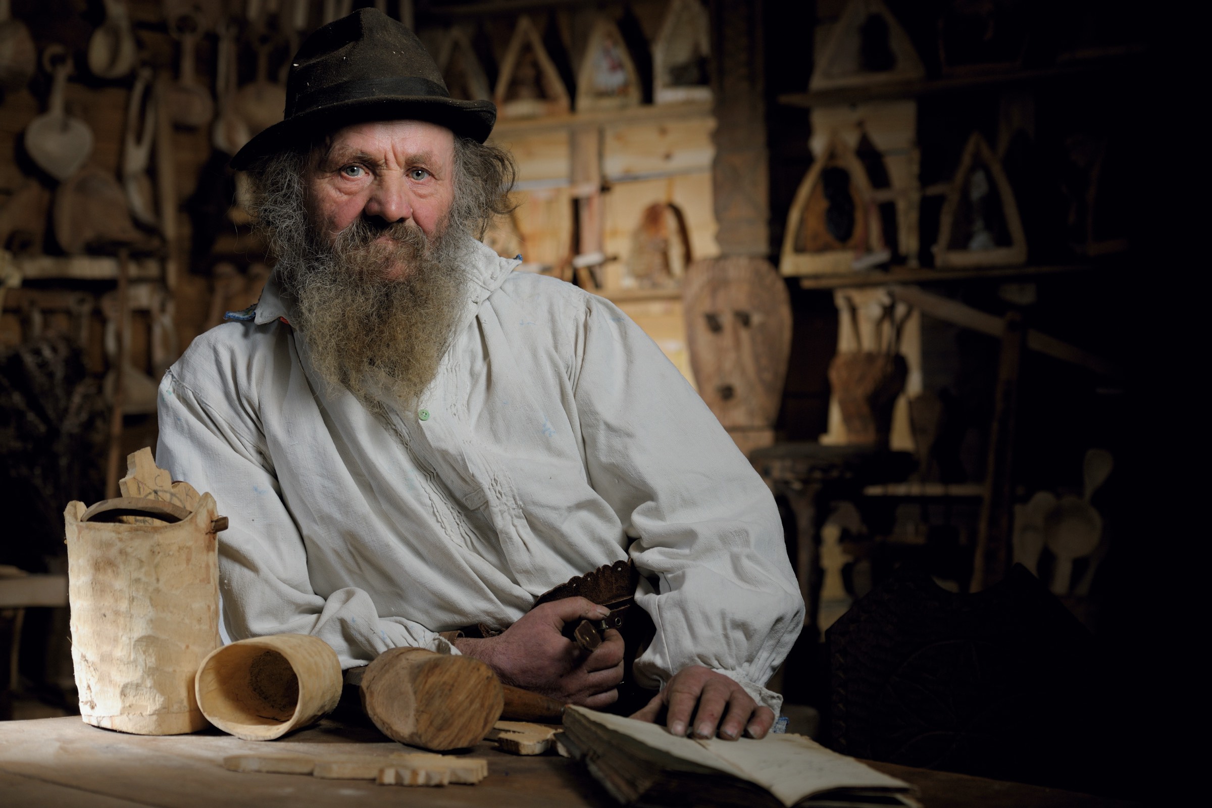 A wood carver in his workshop in Maramureș