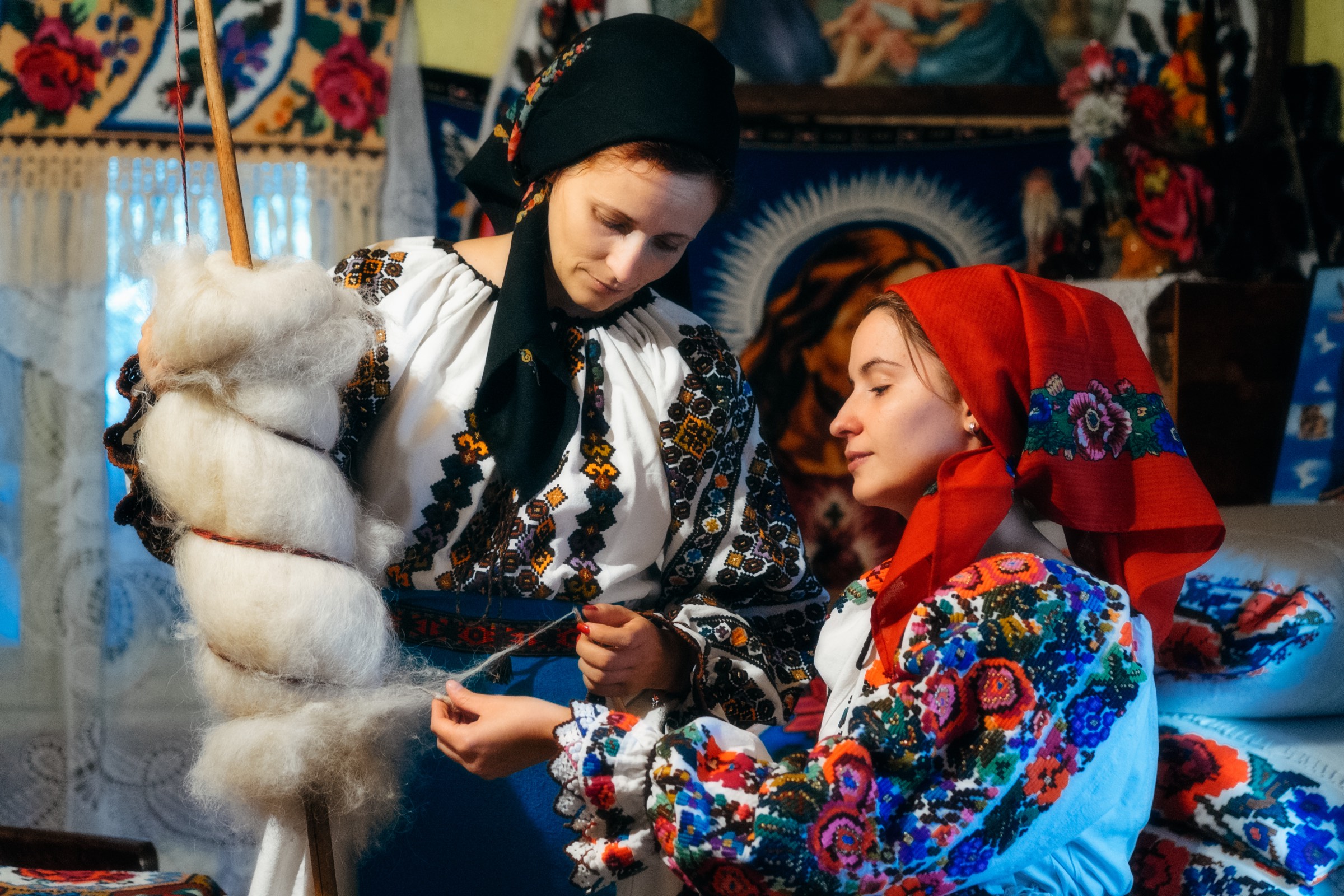 Women in traditional dress spinning wool in Maramureș