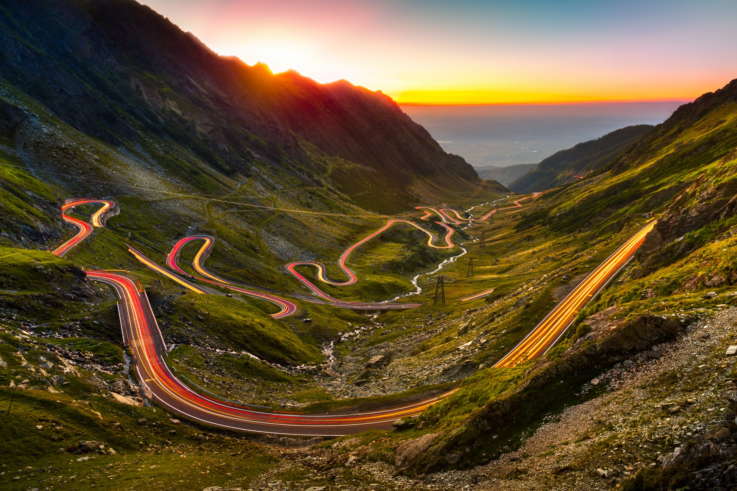 Light trails winding down the Transfăgărășan at sunset