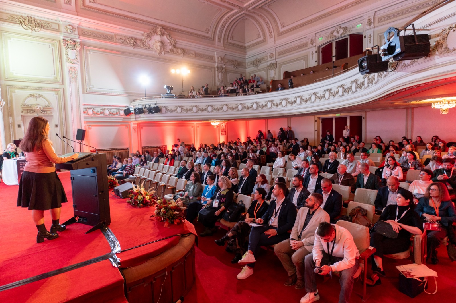 A speaker addressing a full medical congress hall