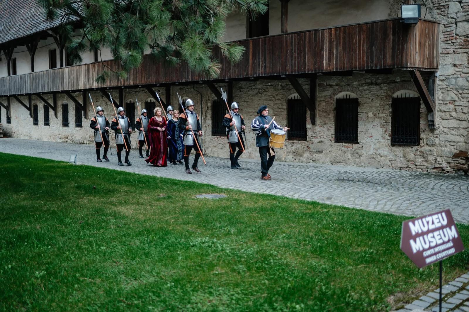 Costumed guards welcoming guests inside a citadel