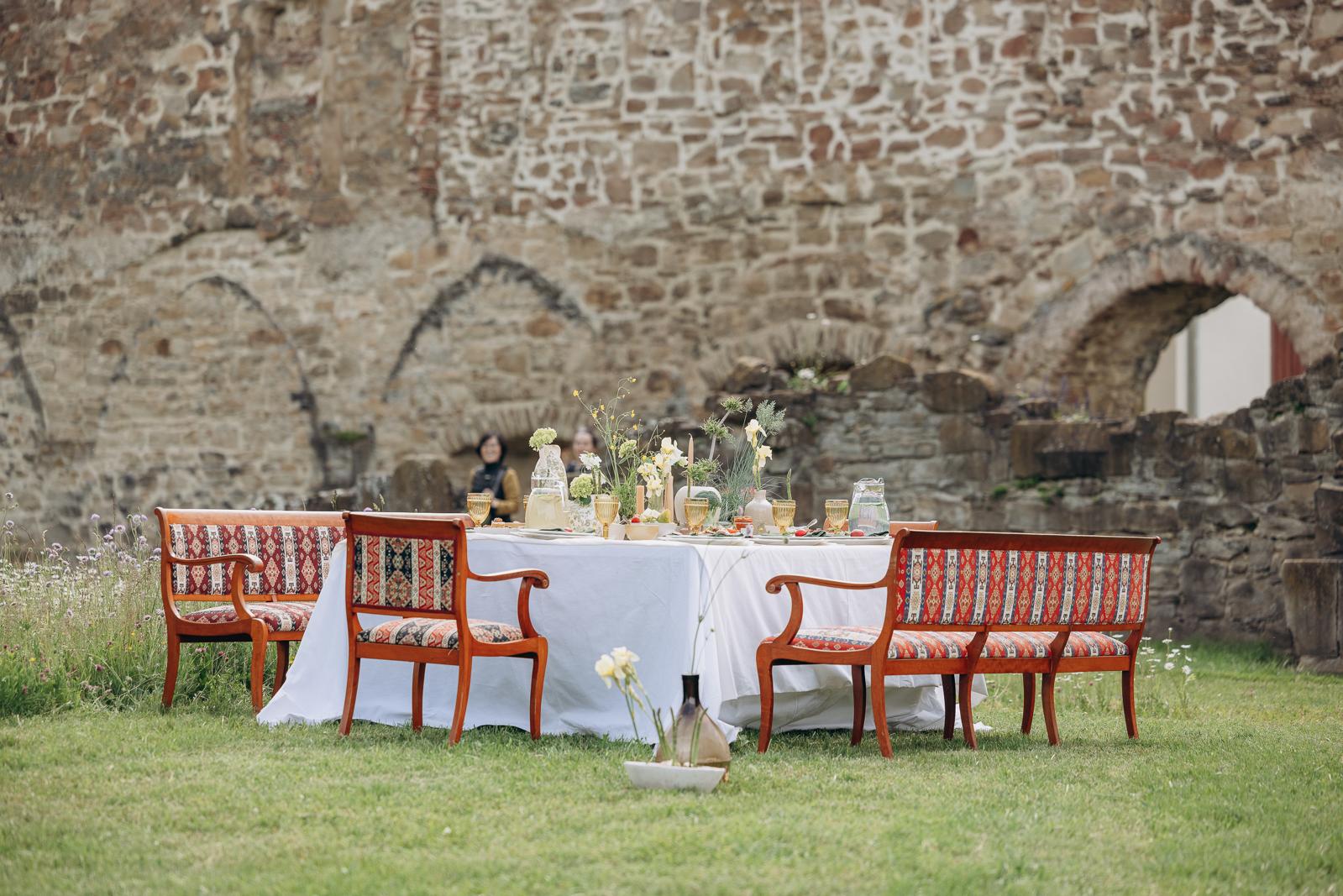 A private dinner table set against centuries-old walls